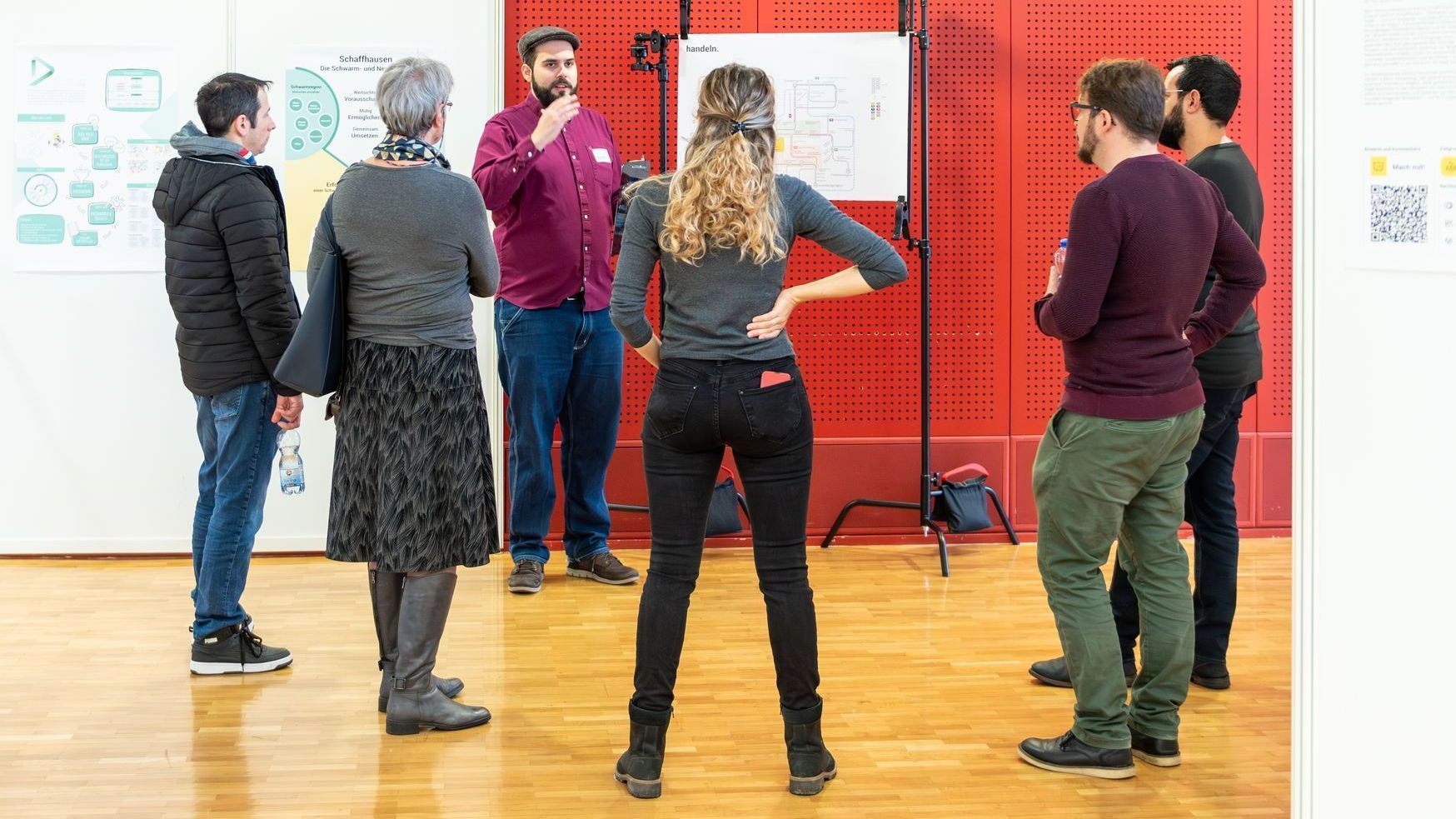 Ein Mann mit Brille und gestreiftem Hemd steht in einem Park.
