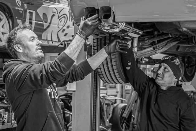 Front of DCH Autosports HQ in Chch with 4 BMW's and a Golf in the carpark