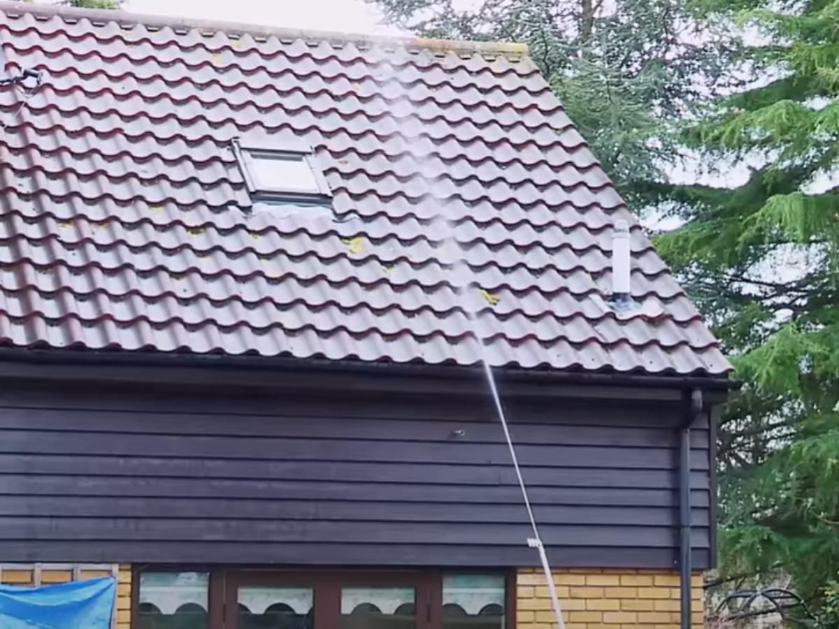 wetting the roof ready for BioWash cleaning