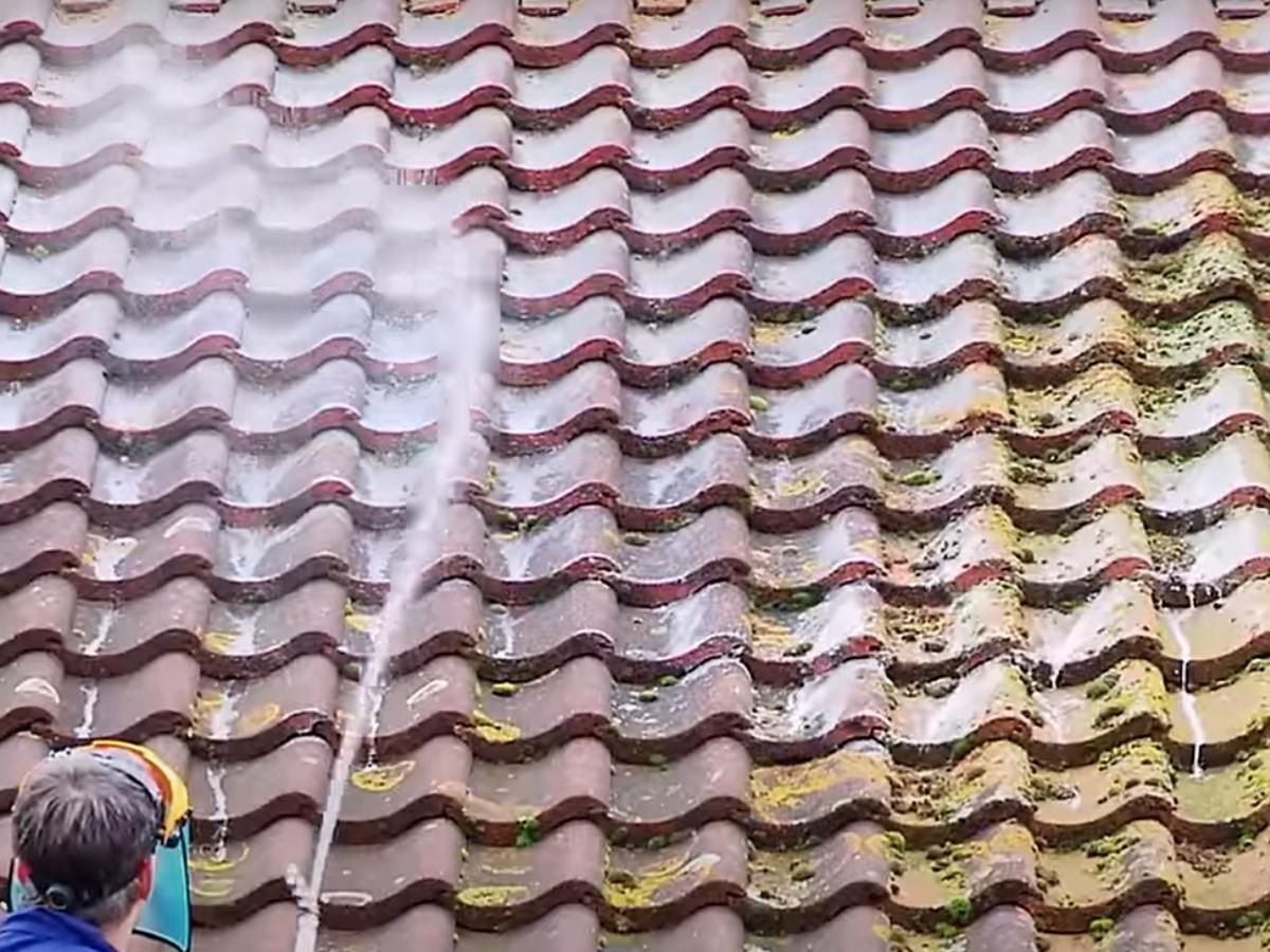 rinsing off BioWash cleaning fluid from the roof