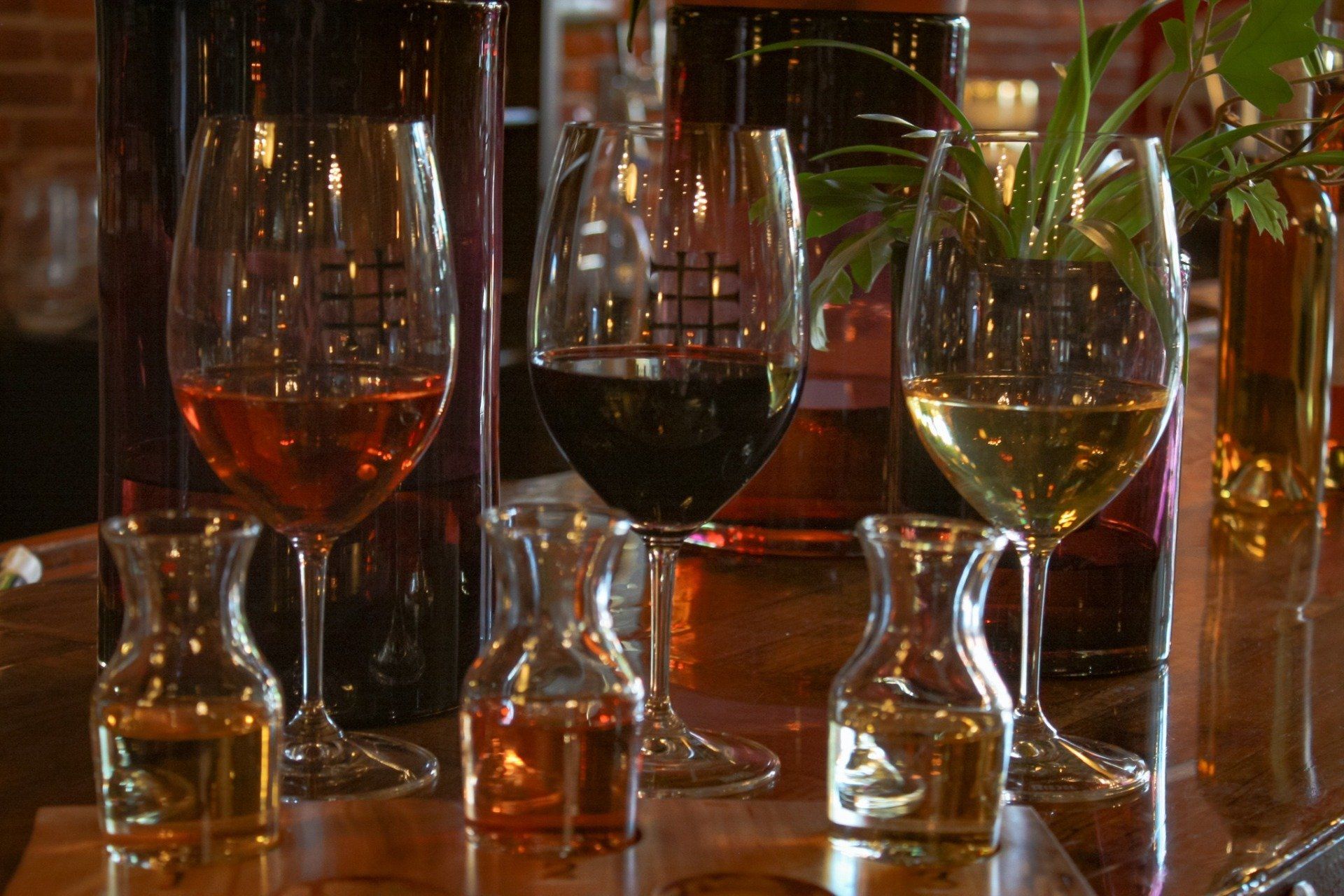 A row of wine glasses sitting on top of a wooden table.