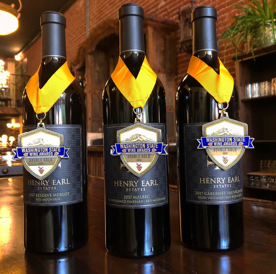 Three bottles of henry earl wine are on a table