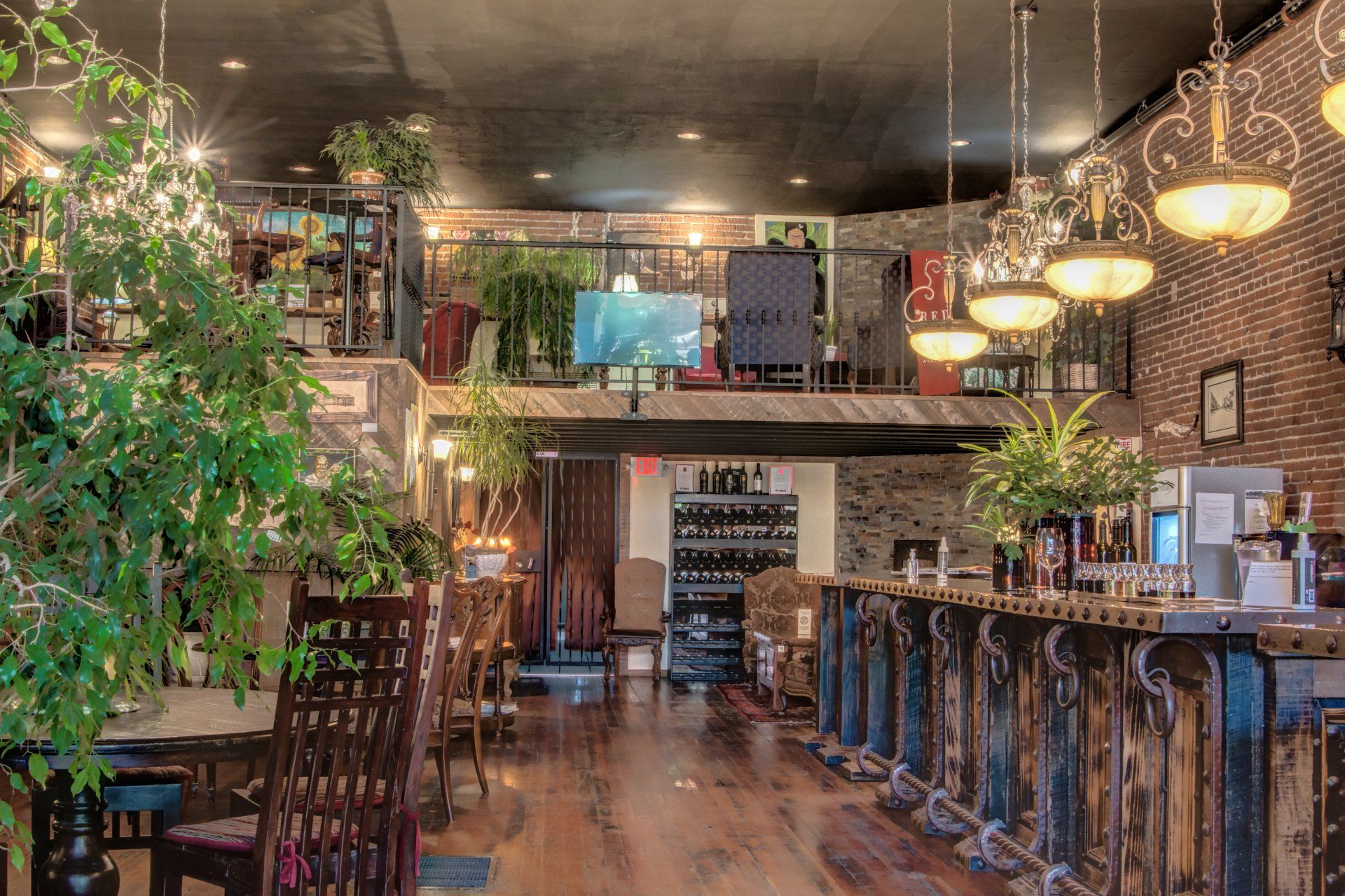 The inside of a restaurant with tables and chairs and a bar.