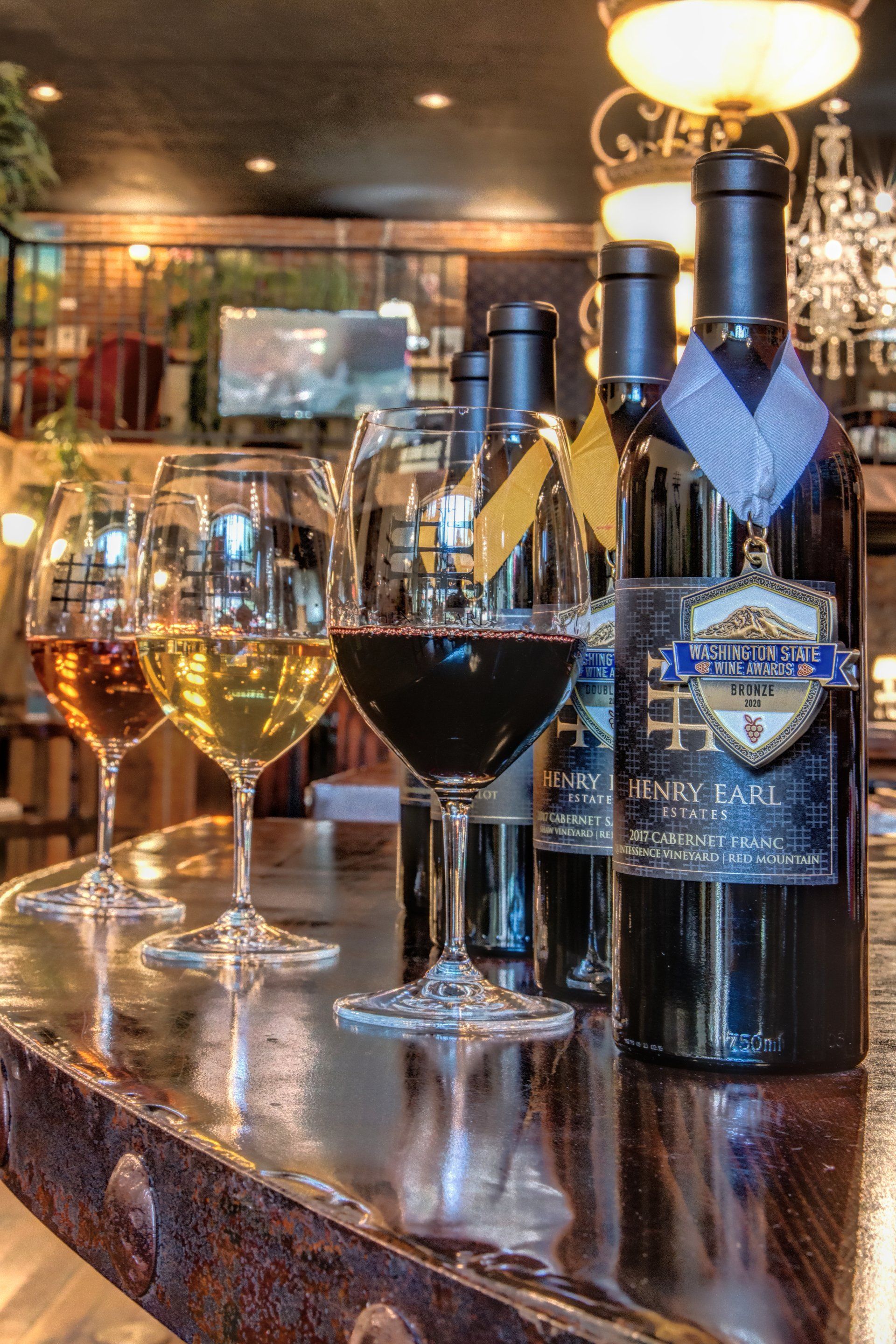 Bottles of wine and wine glasses on a bar