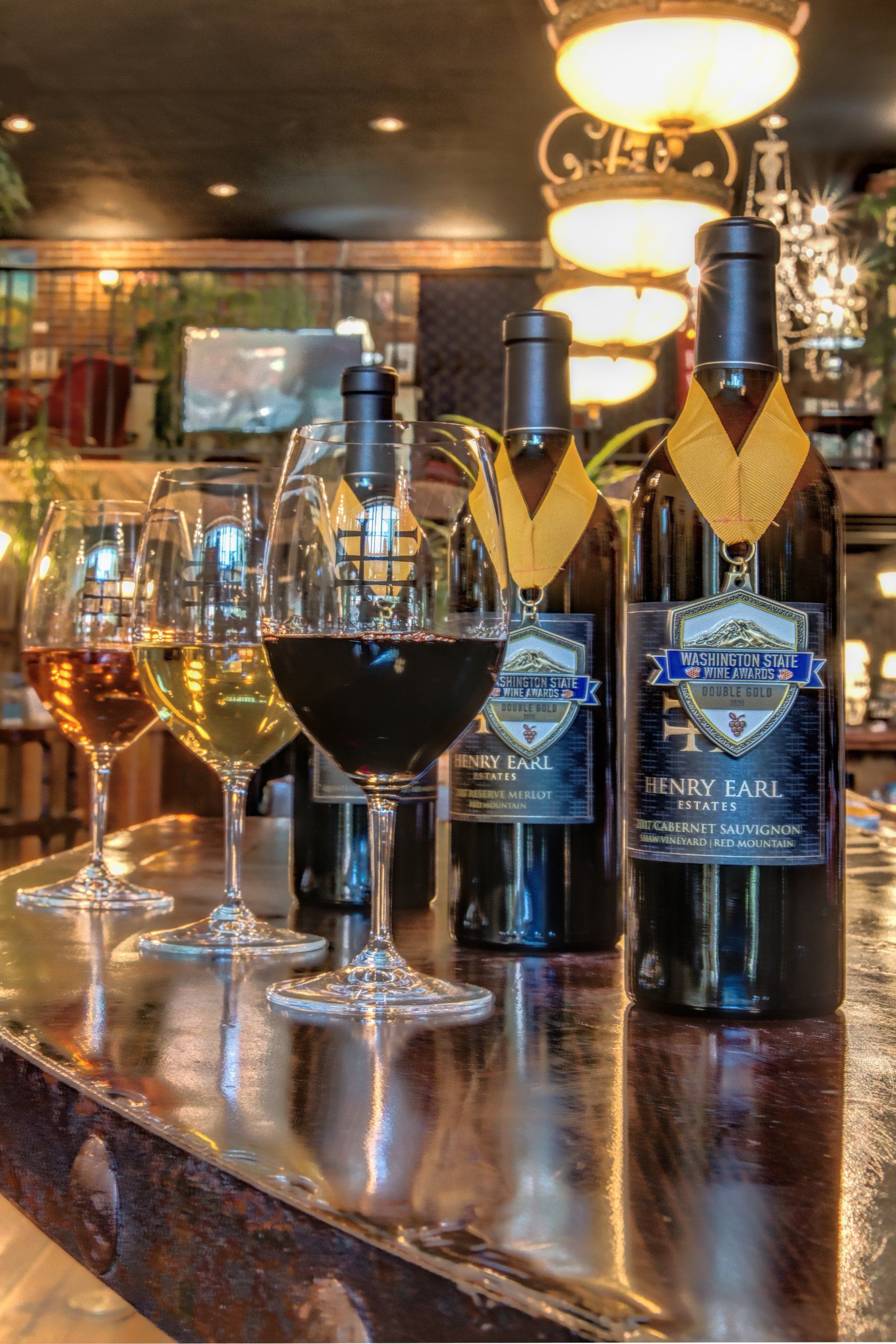 Bottles of wine and wine glasses on a bar