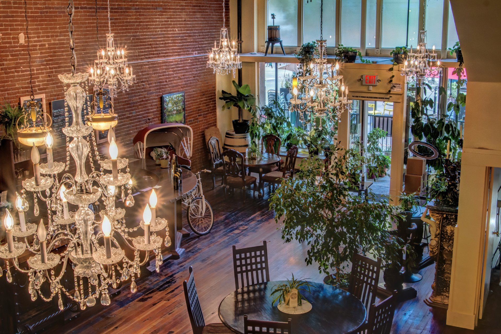 A large room with tables and chairs and a chandelier hanging from the ceiling