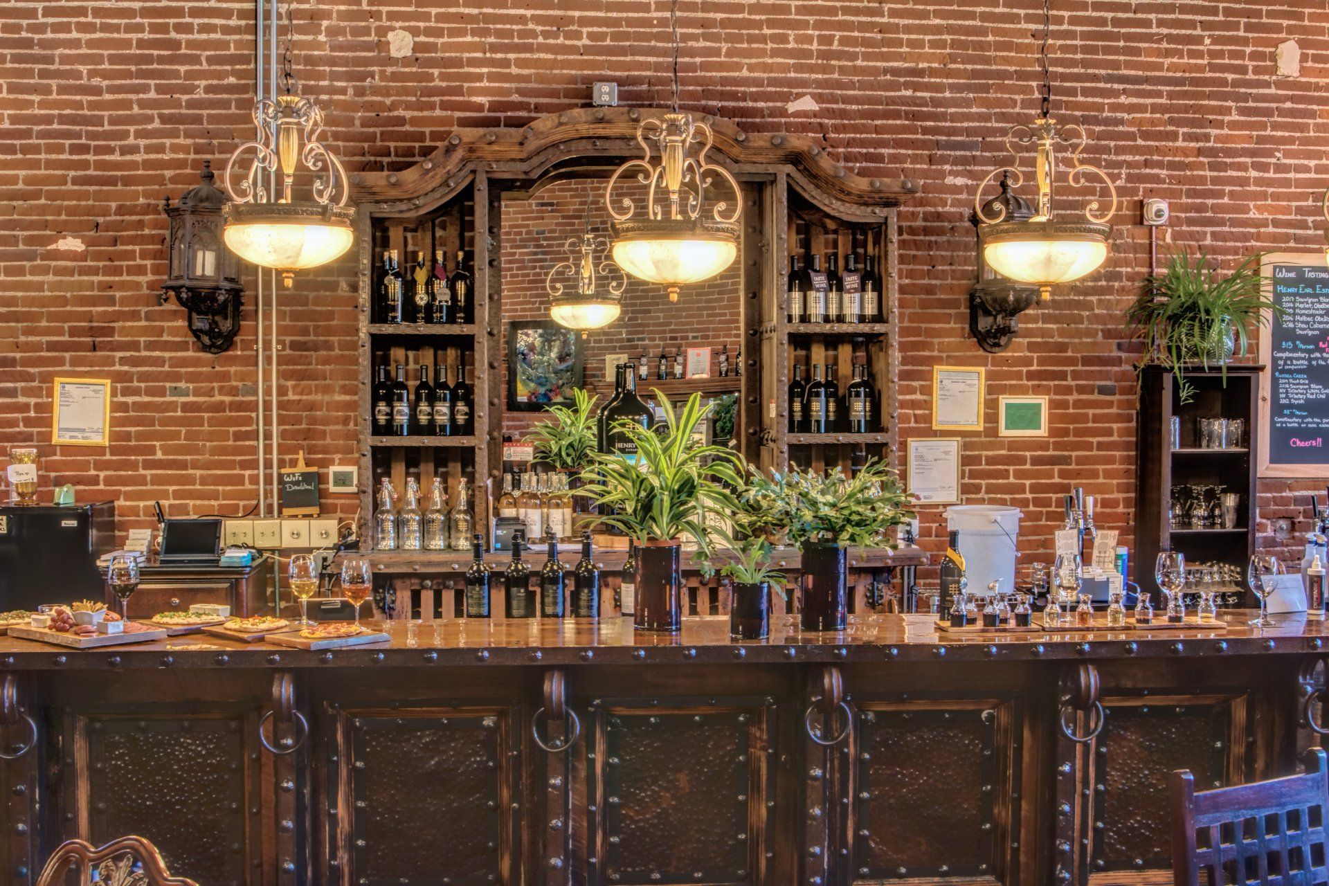 A bar in a restaurant with a brick wall behind it