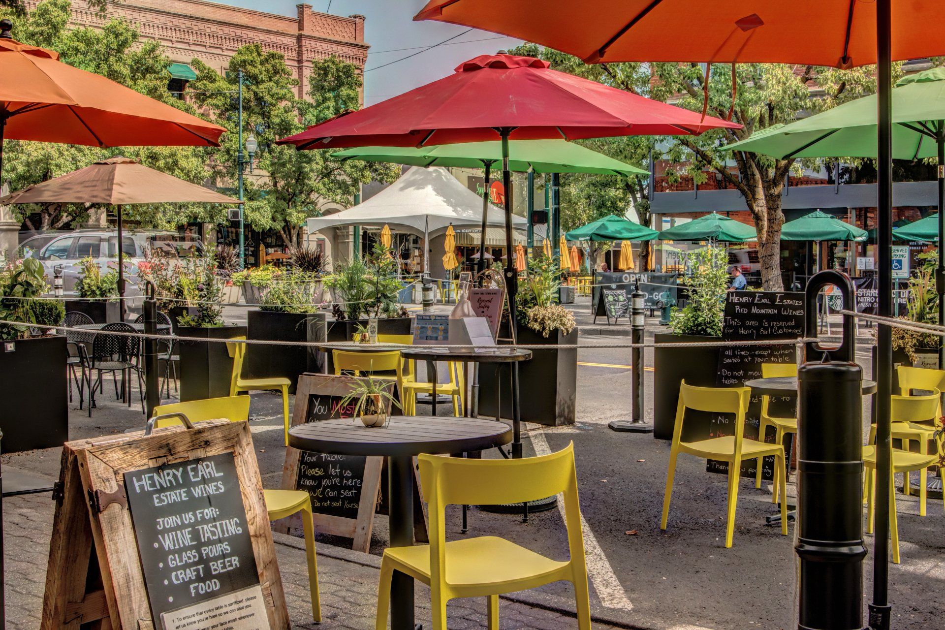 A restaurant patio with tables and chairs and umbrellas