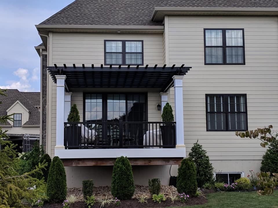 A house with a large deck and stairs leading up to it.