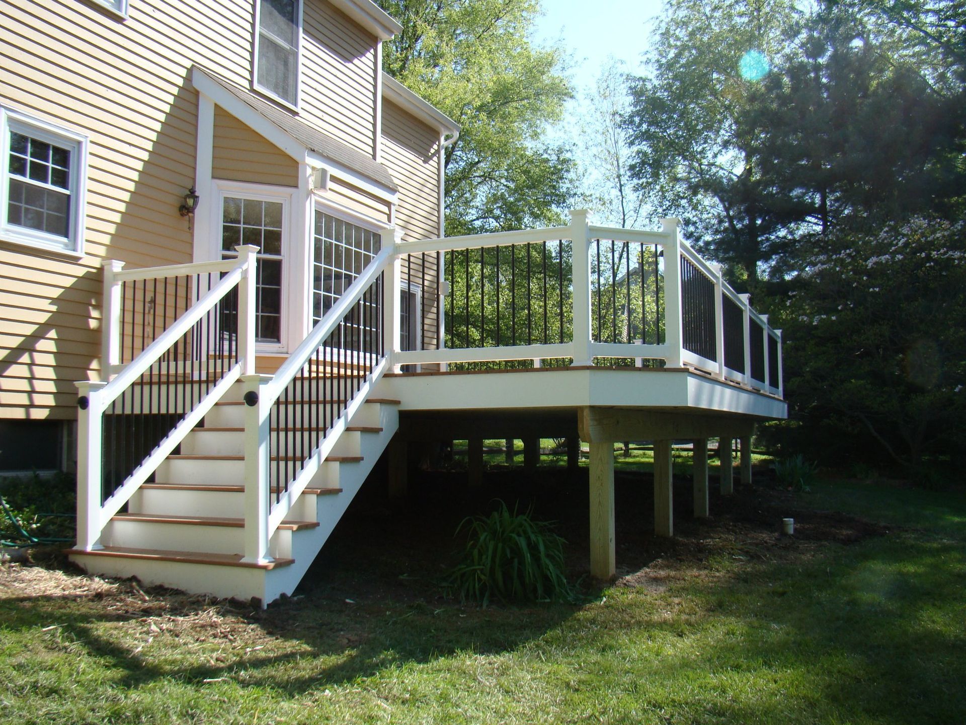 A house with a deck and stairs leading up to it