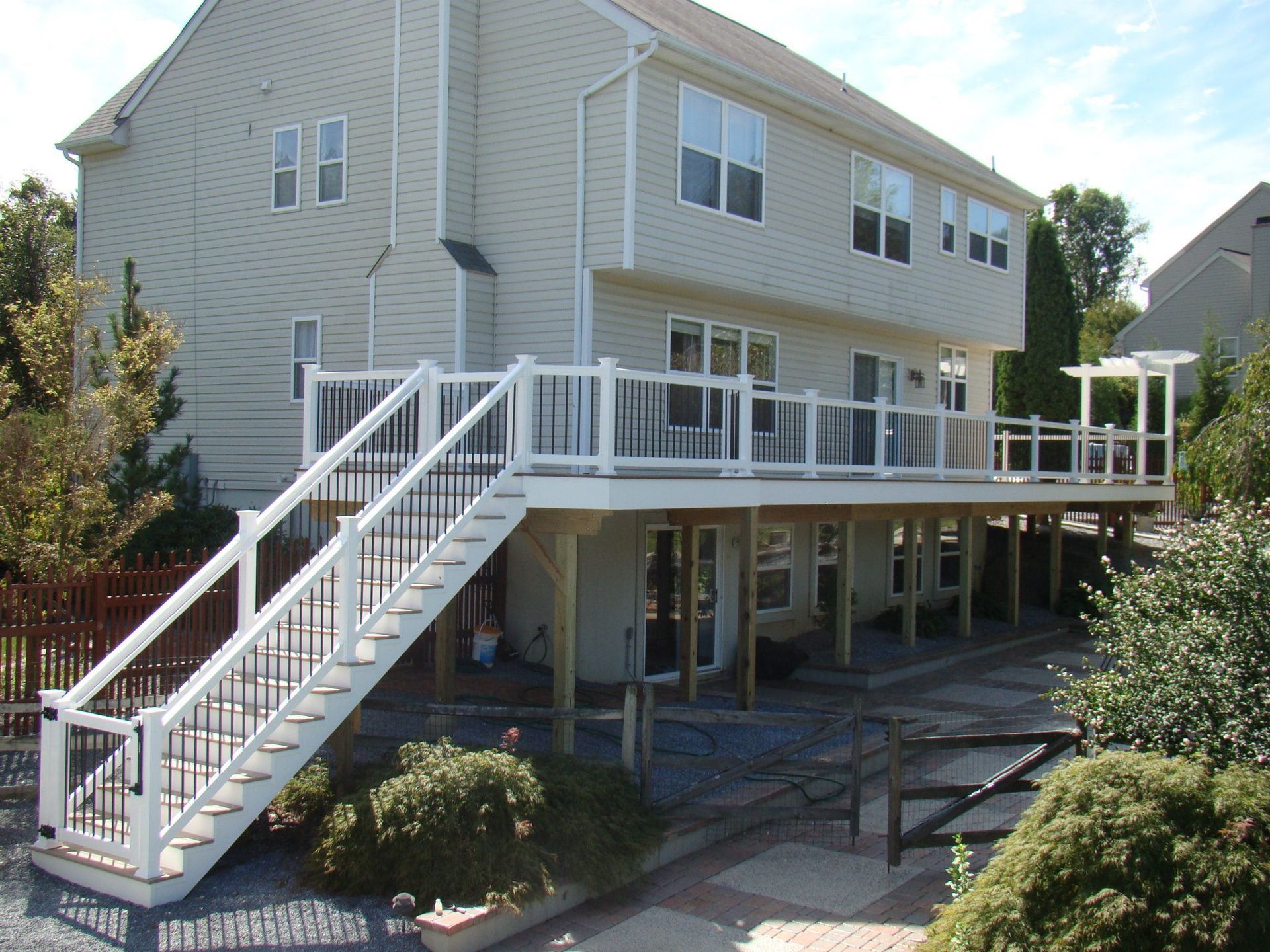 A house with a large deck and stairs leading up to it