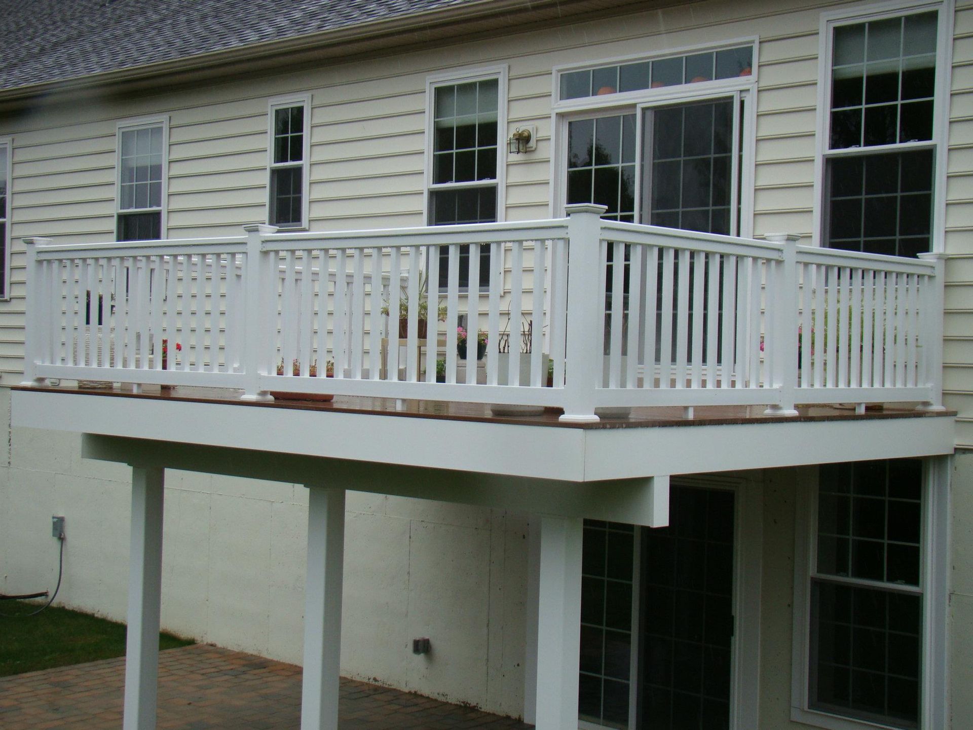 A white house with a balcony with a white railing