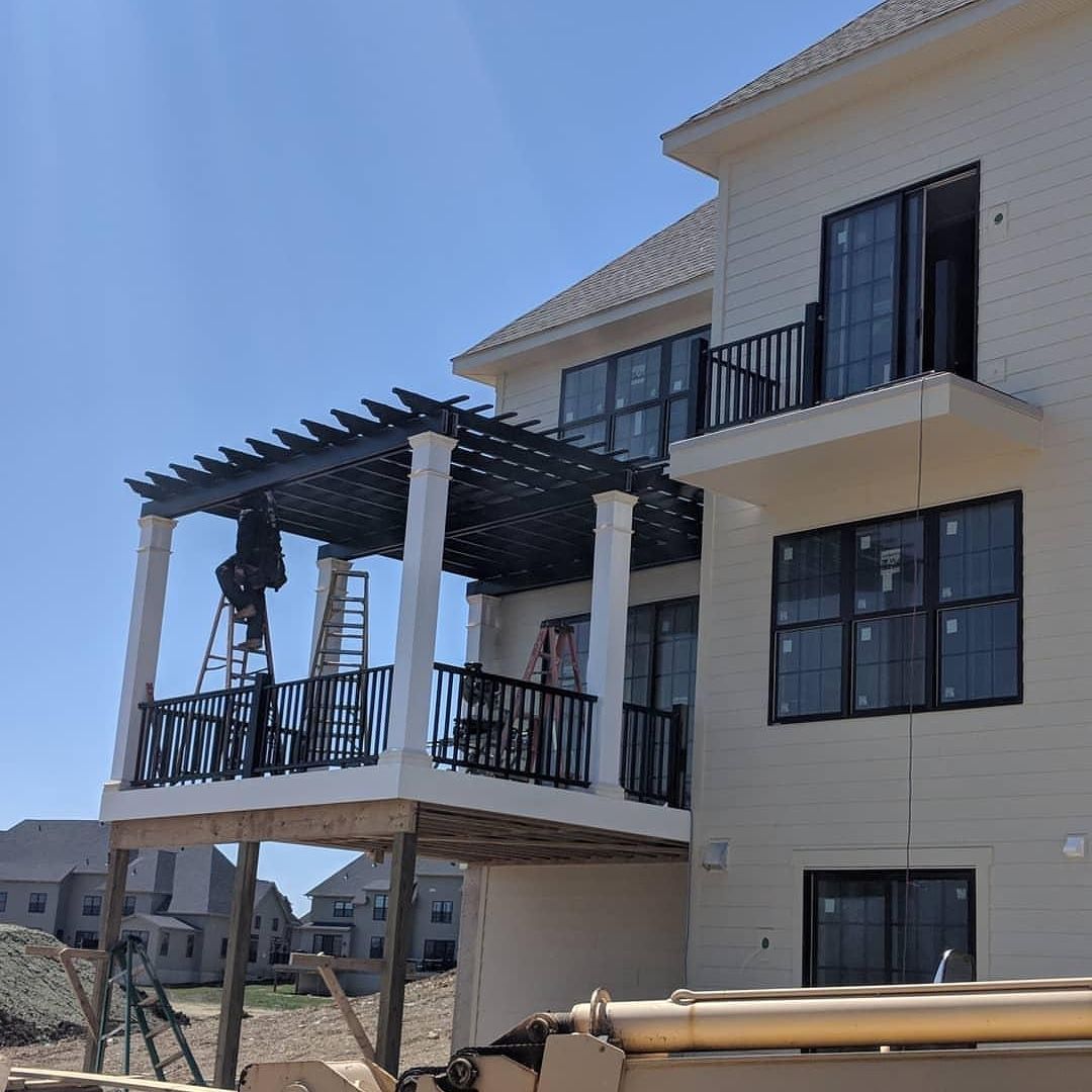 A large white house with a balcony and a pergola