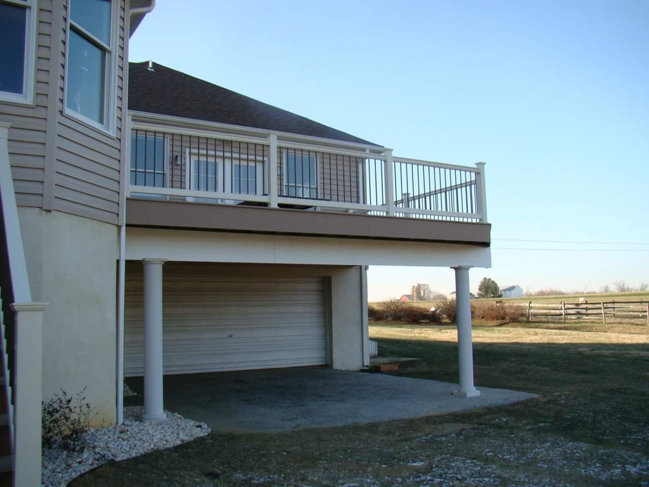 A house with a large deck and a garage underneath it