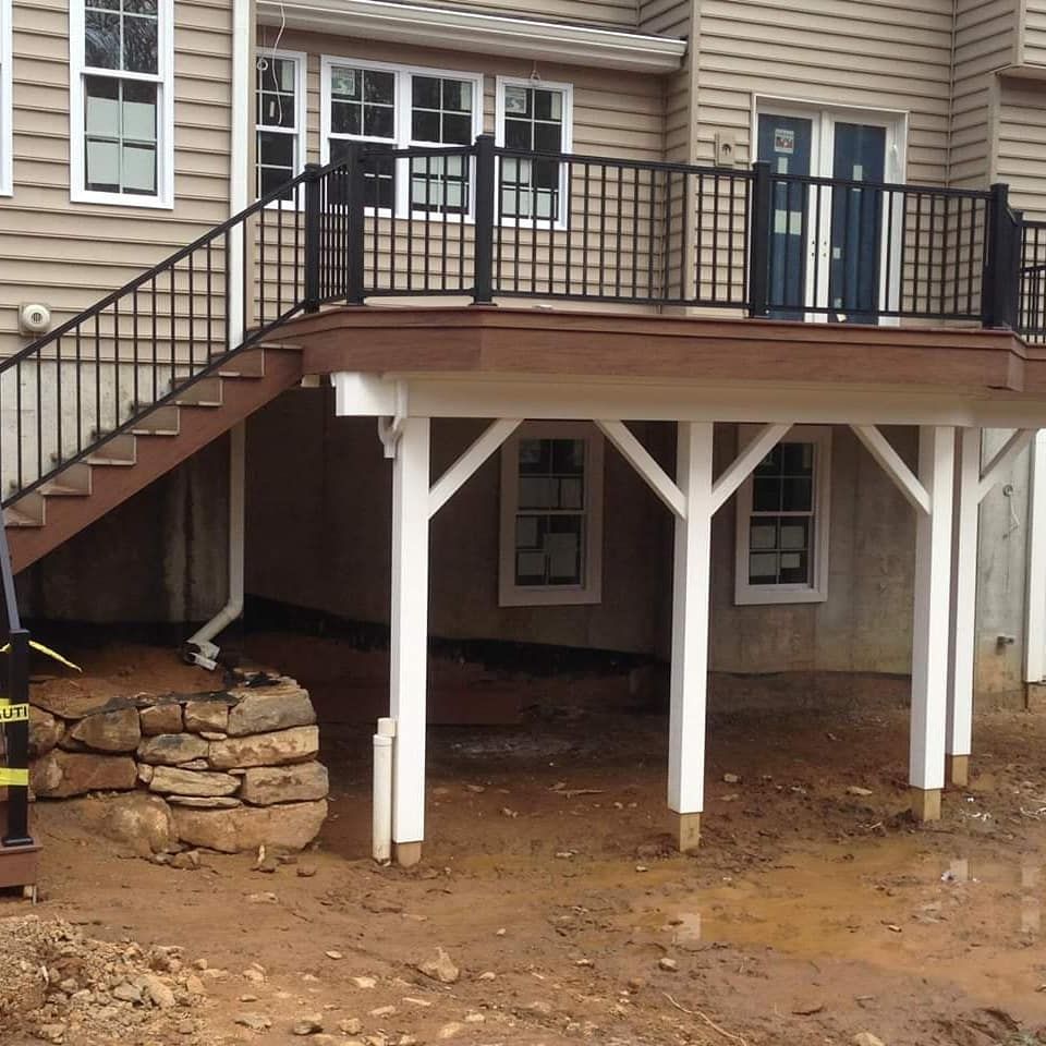 A house with a deck and stairs leading up to it