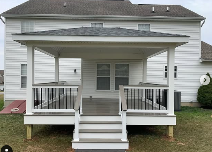 A house with a screened in porch and lots of windows