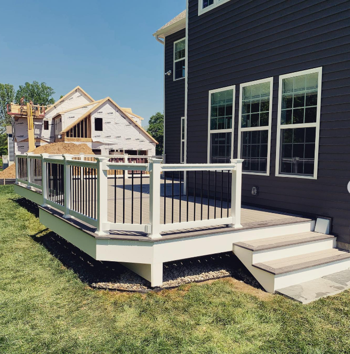A wooden deck with a yellow lawn mower on it.