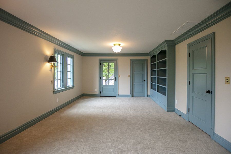 A Spacious Room With Blue Baseboards & Doors By Mid-MO's Remodelers, New Beginnings.
