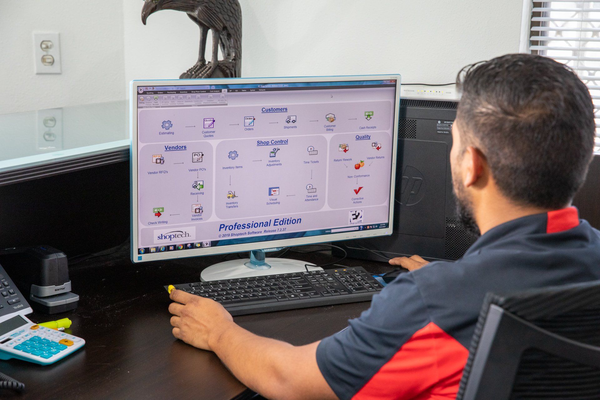 man working on computer at desk