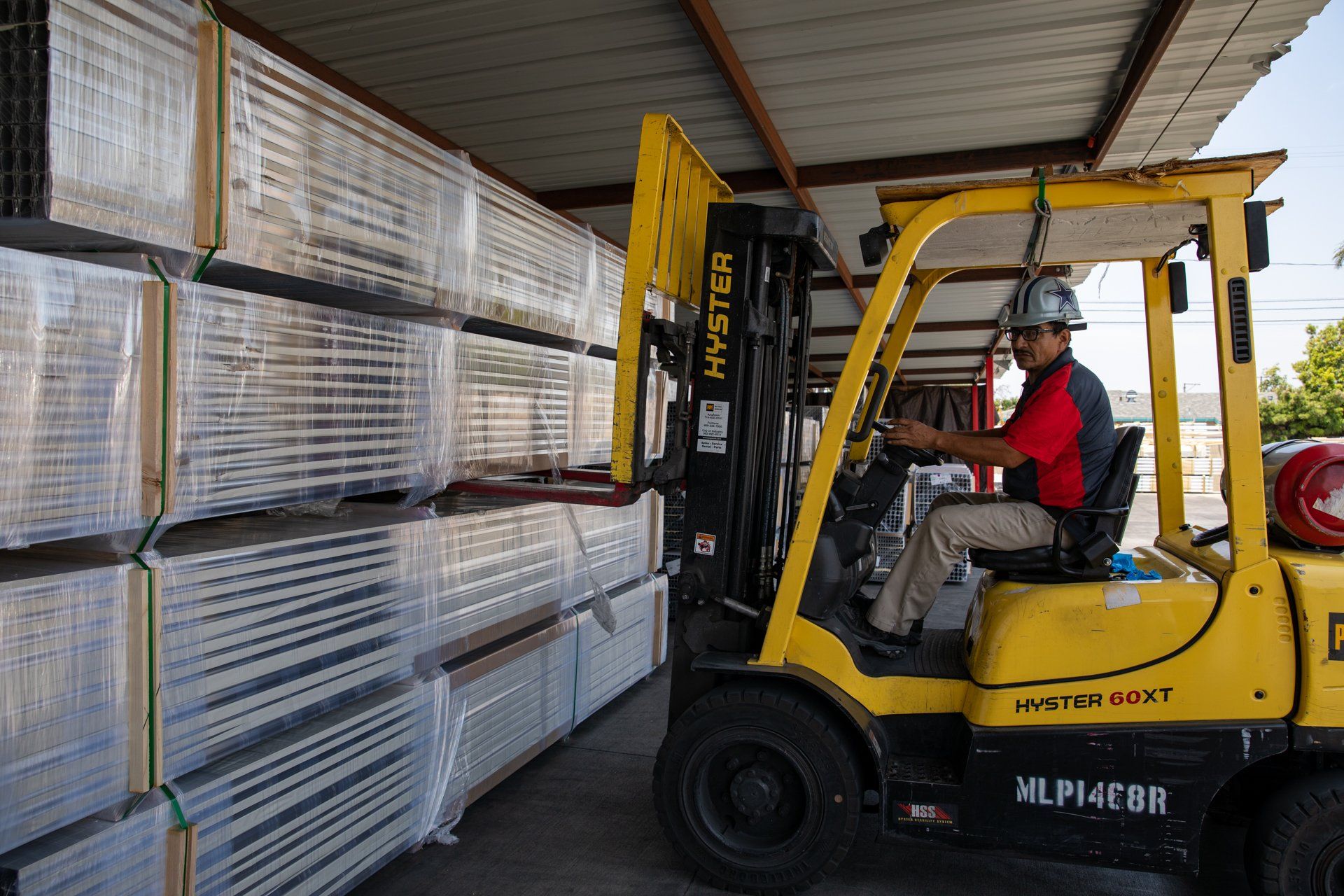 forklift picking up a large bundle of metal