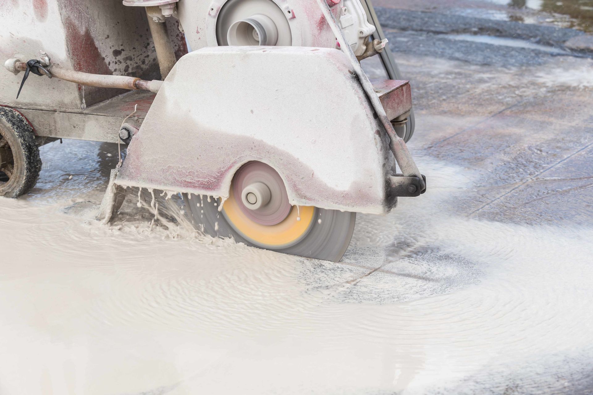 a machine cutting wet concrete