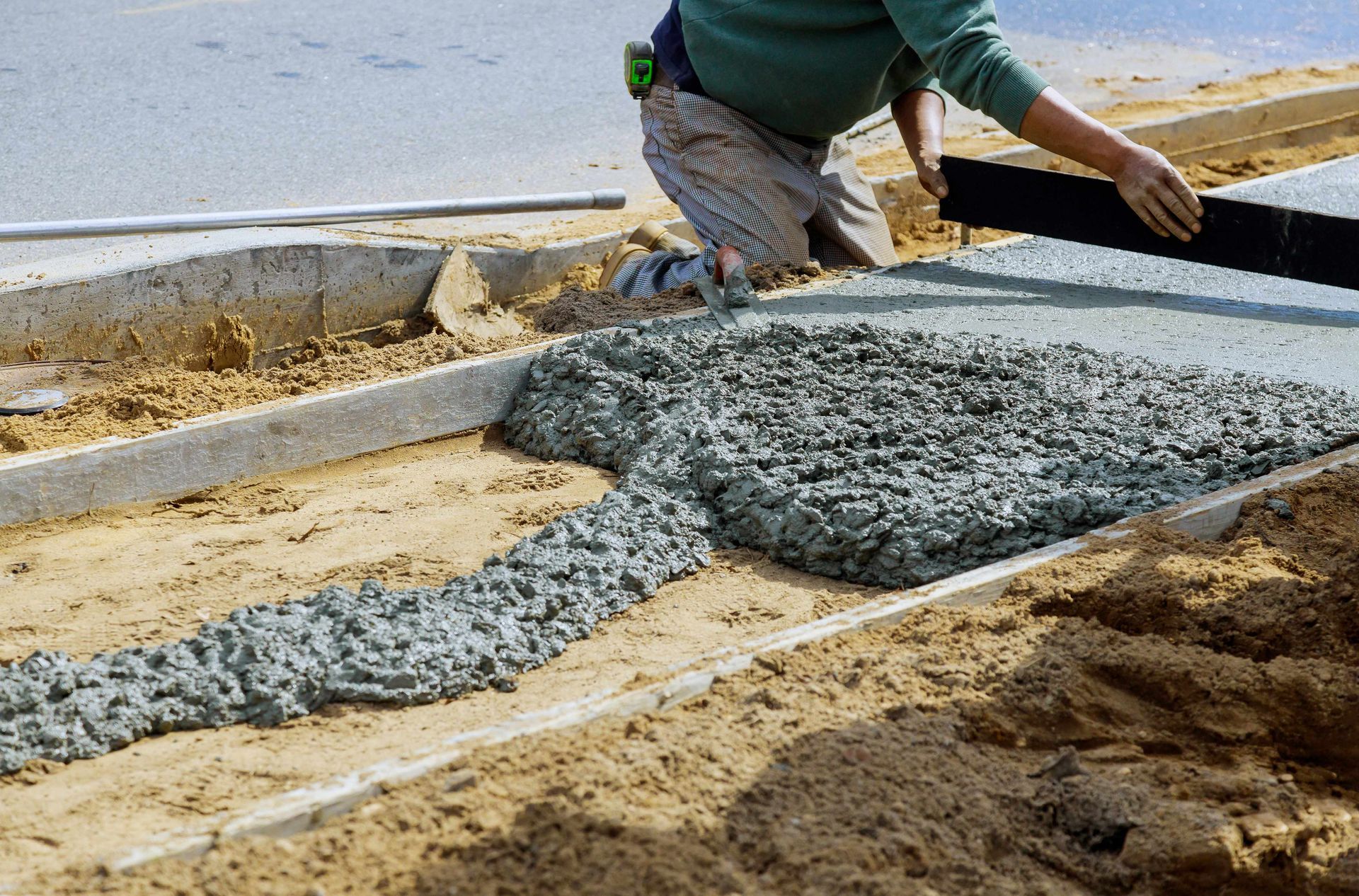 A man directing poured concrete