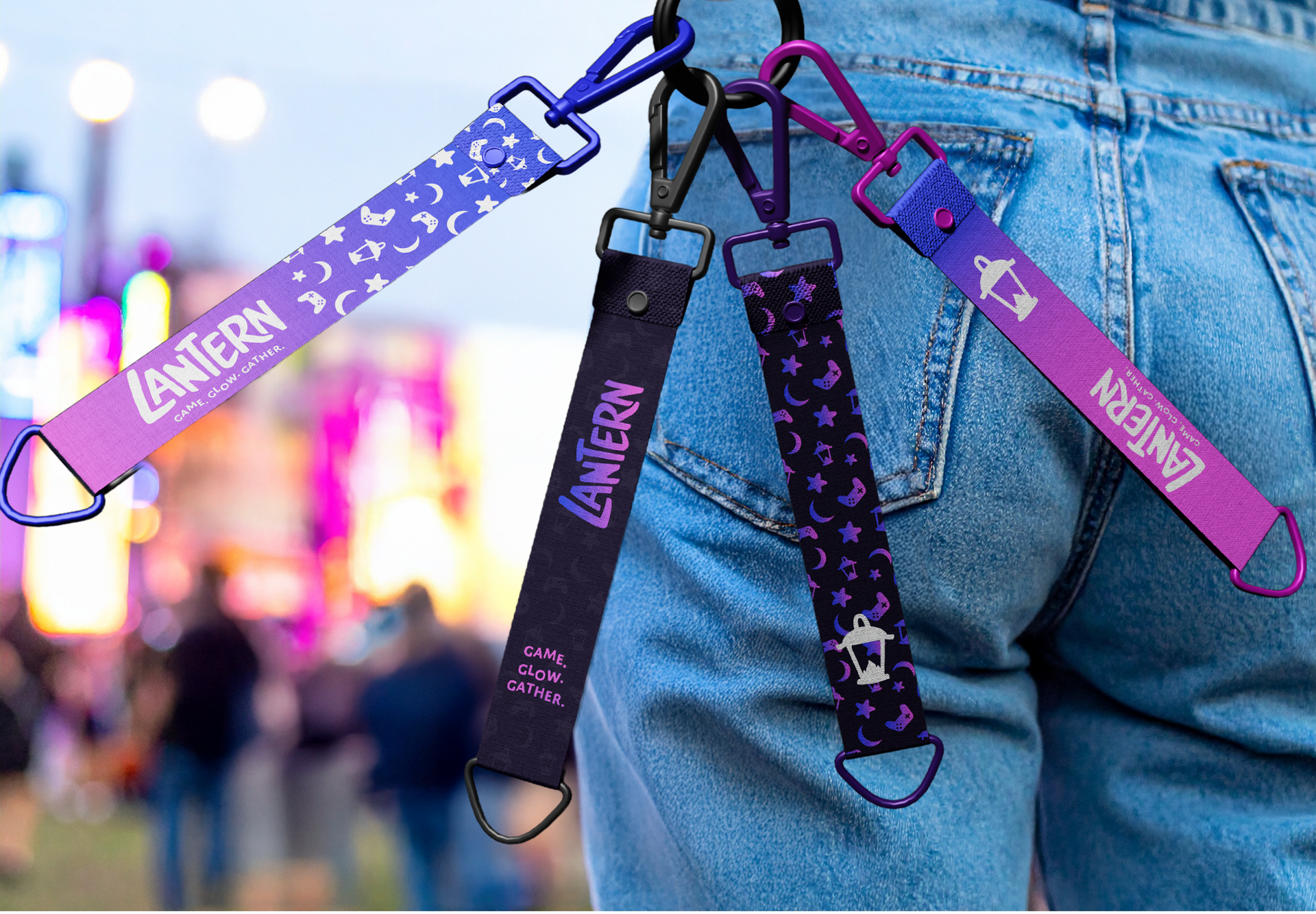 Close-up of denim jeans with several purple and black straps and clips attached at the waist
