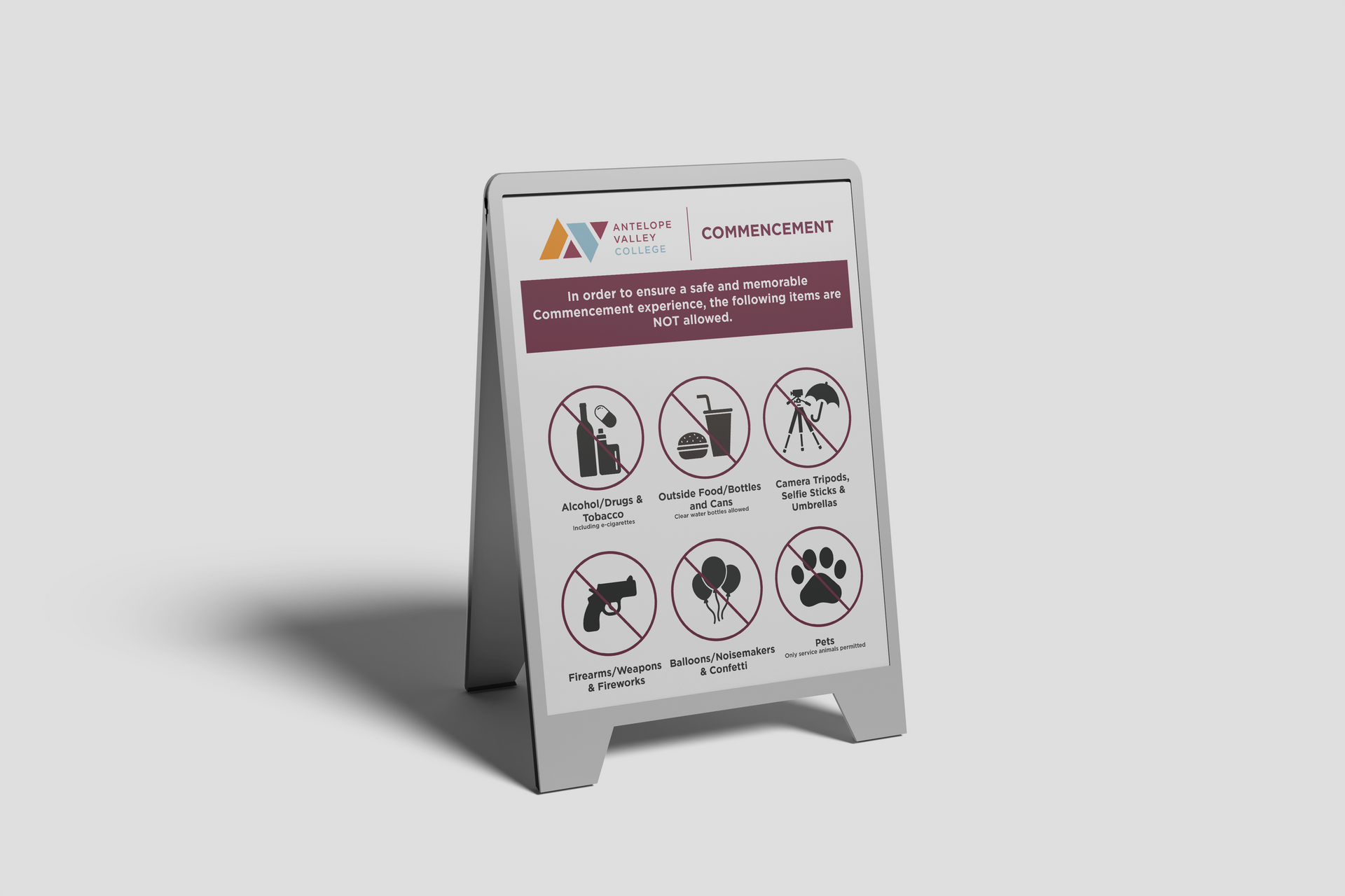 Freestanding safety sign with warning icons on a gray floor