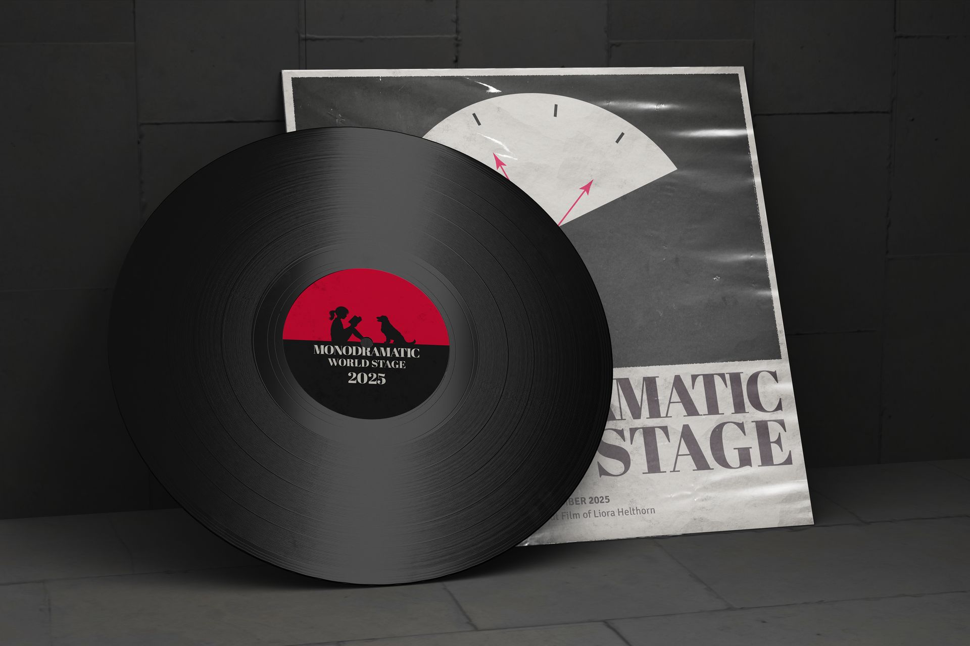 Black vinyl record with red-and-black label in front of a gray album cover on a dark surface