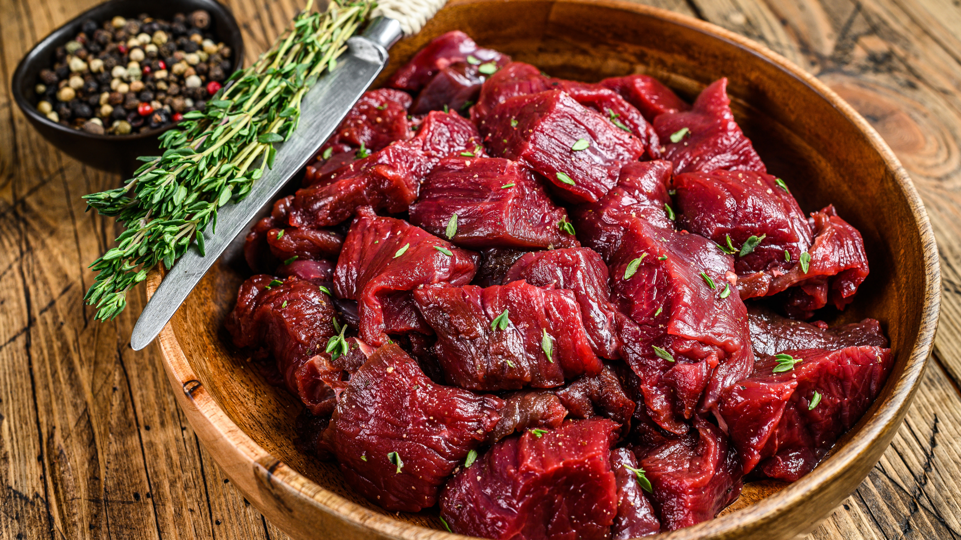 Red meat in a wooden bowl.