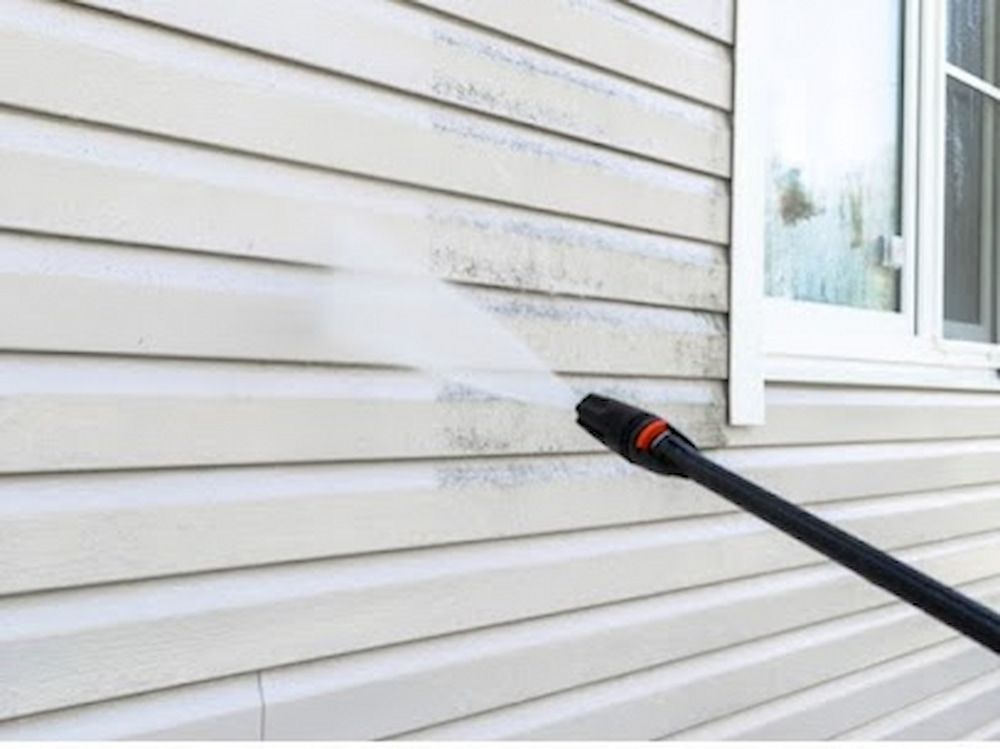 A Person Is Using A High Pressure Washer To Clean — Alta Cleaning Service In Coconut Grove, NT