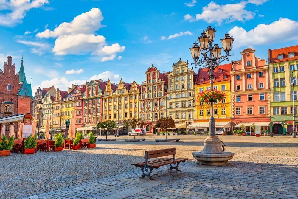 Polish Town square in front of a row of buildings — Métier Medical Ltd in Źródła, Poland