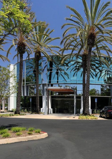 A building with palm trees in front of it