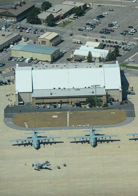 An aerial view of an airport with planes parked on the tarmac