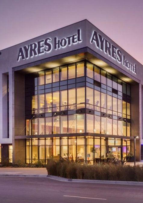 A large building with ayres hotel written on it