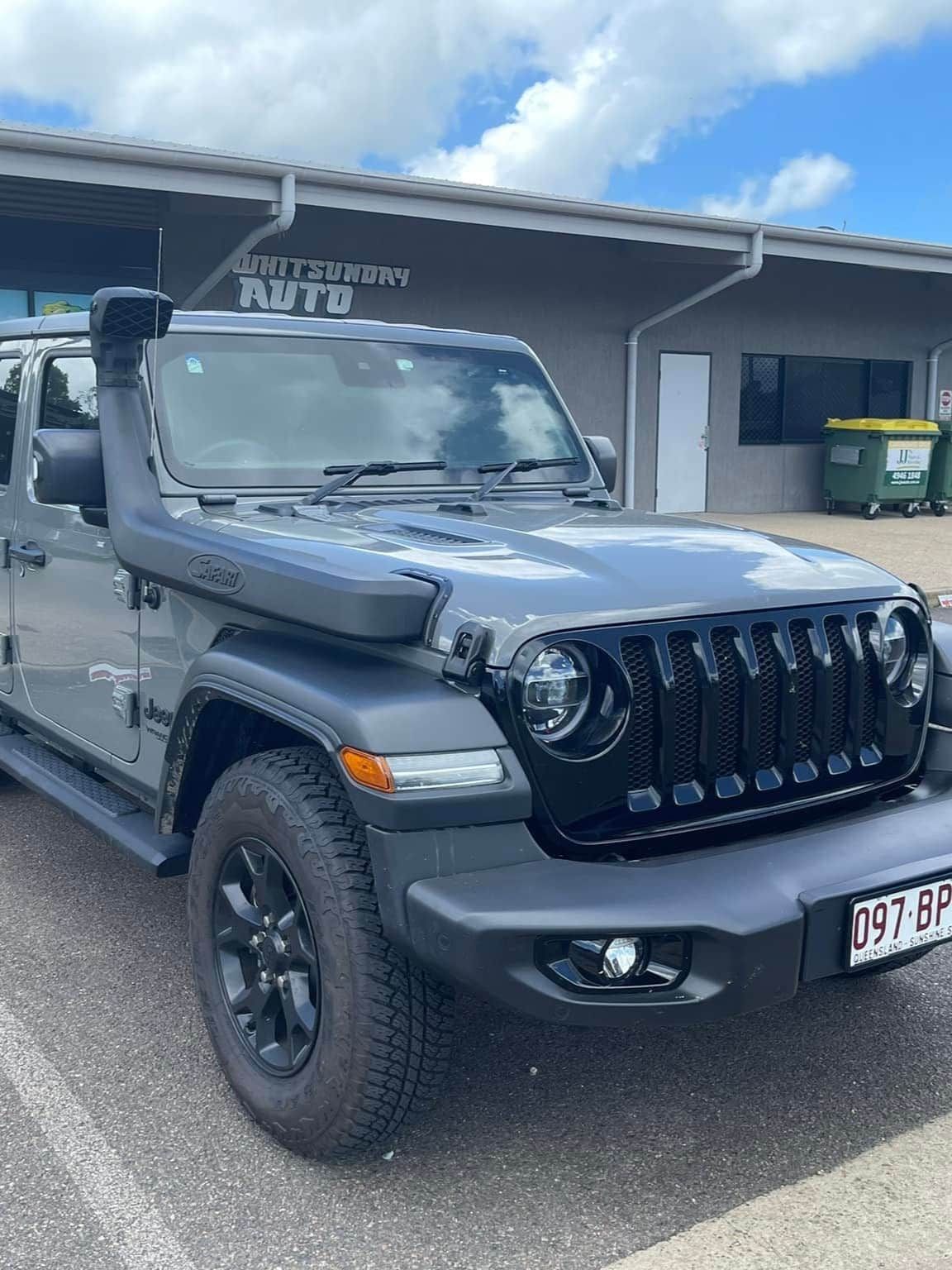 A Jeep Wrangler is Parked in a Parking Lot in Front of a Building — Whitsunday 4x4 & Automotive In Proserpine, QLD
