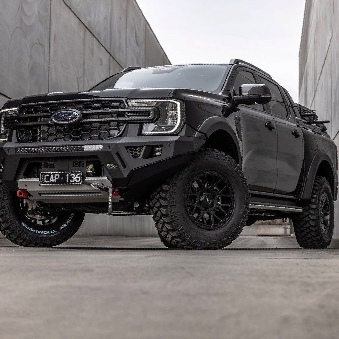 A Black Truck is Parked in Front of a Concrete Wall — Whitsunday 4x4 & Automotive In Cannonvale, QLD