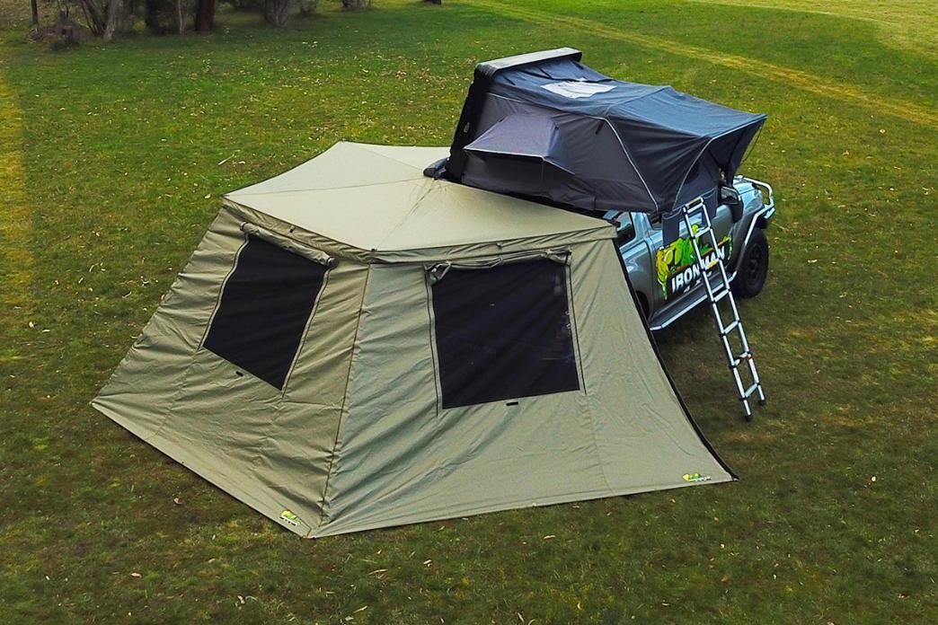 A tent is sitting on top of a jeep in the grass - Whitsunday 4x4 & Automotive In Cannonvale, QLD