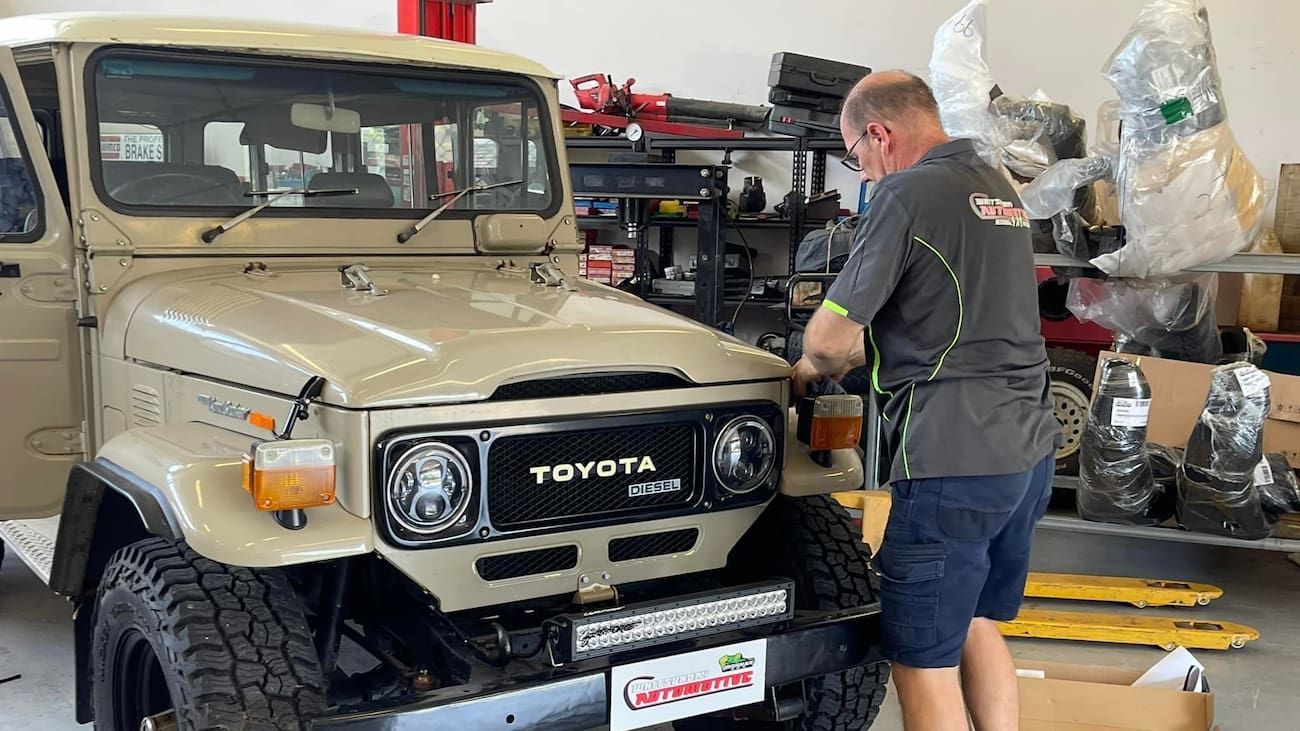 A Man is Working on a Toyota Truck in a Garage — Whitsunday 4x4 & Automotive In Proserpine, QLD
