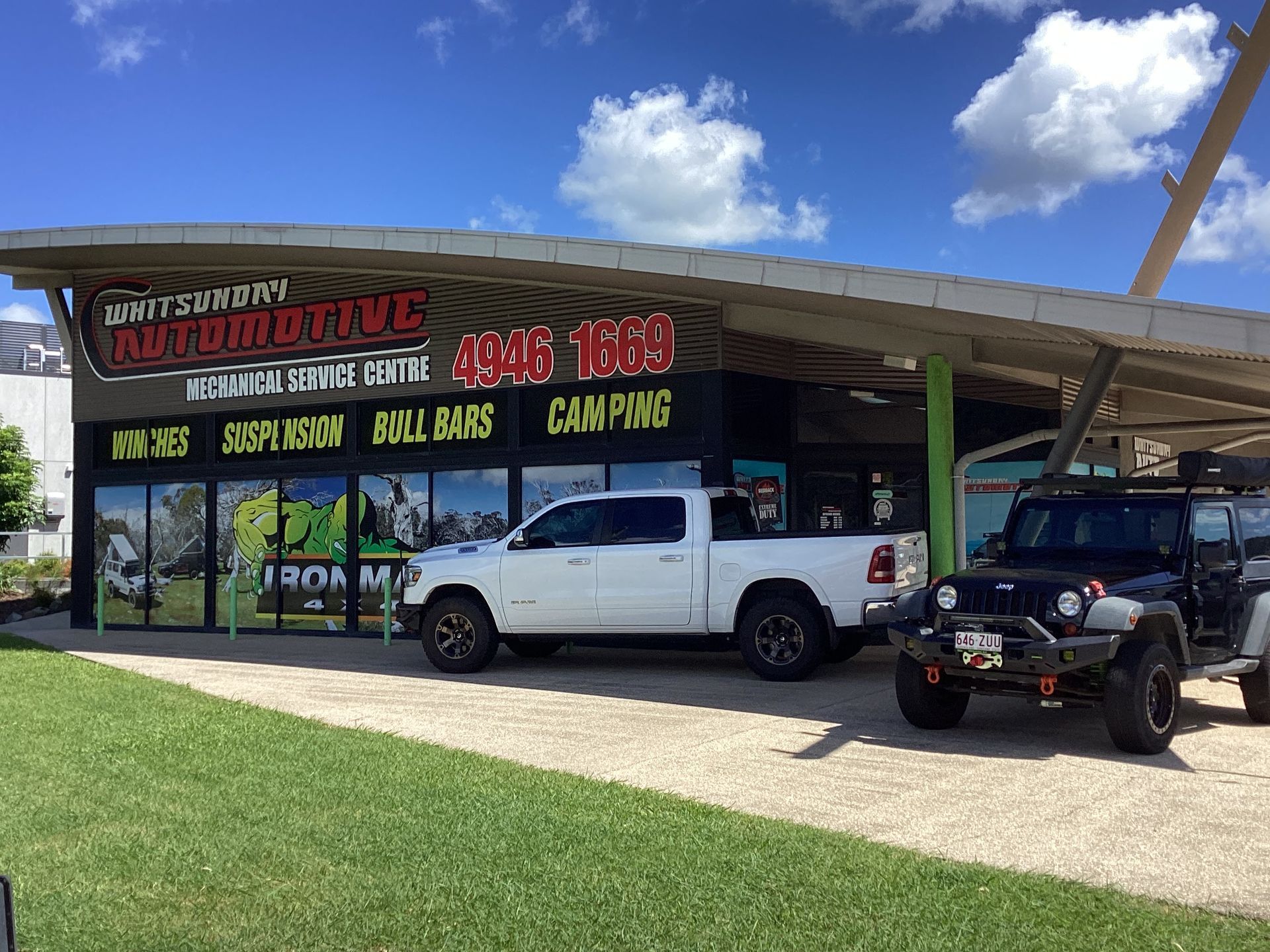A Man and a Woman Are Sitting In A CAr — Whitsunday 4x4 & Automotive In Cannonvale, QLD