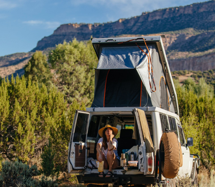 A Car with a Tent on Top of it in the Woods - Whitsunday 4x4 & Automotive In Cannonvale, QLD