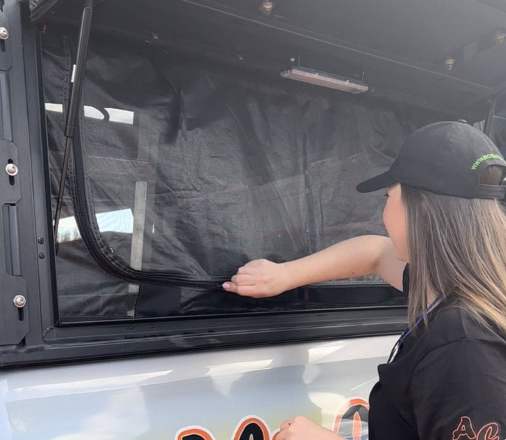 A Woman in a Black Hat is Looking Out of a Car Window - Whitsunday 4x4 & Automotive In Cannonvale, QLD