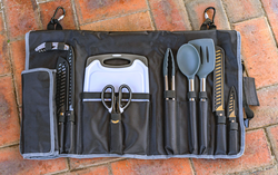 A black bag filled with utensils and a cutting board