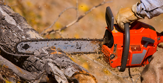 chainsaw cutting into a log