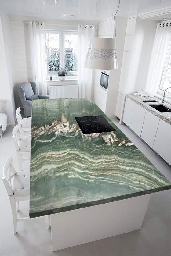 A kitchen with a green granite counter top and white cabinets.