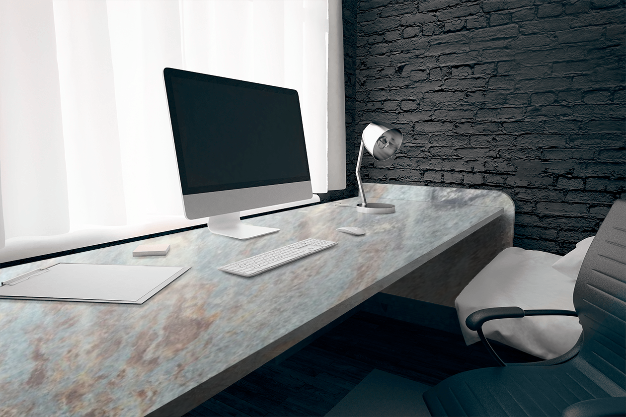 A desk with a computer and a lamp on it.