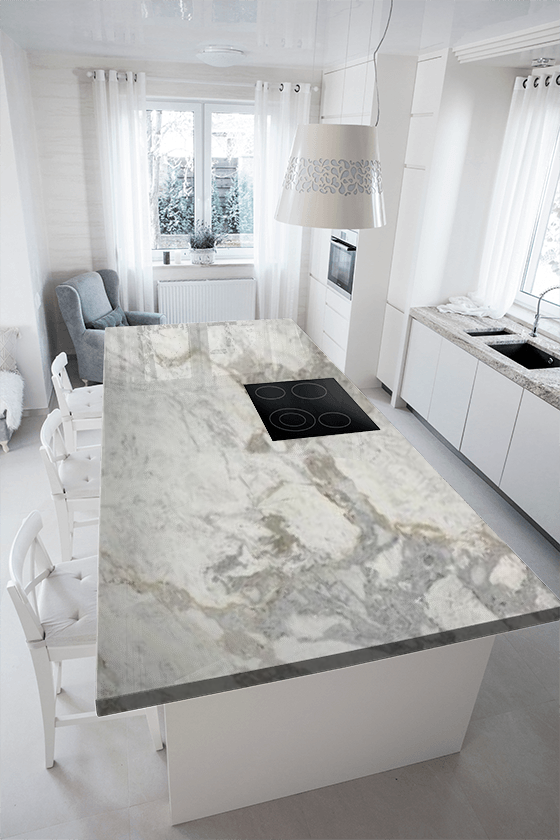 A kitchen with a large marble counter top and white cabinets.