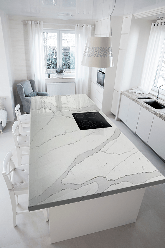 A kitchen with a large island and a stove top oven.