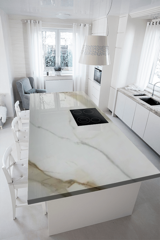 A kitchen with a large island and a stove top oven.