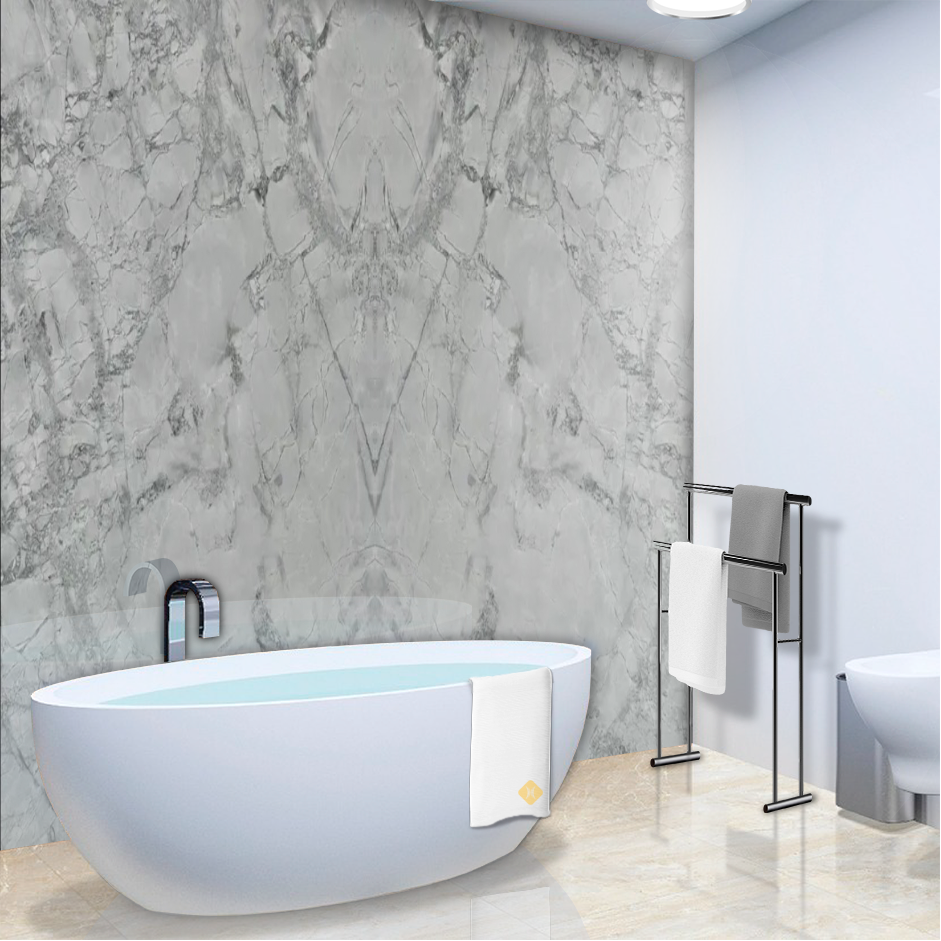 A bathtub in a bathroom with a marble wall
